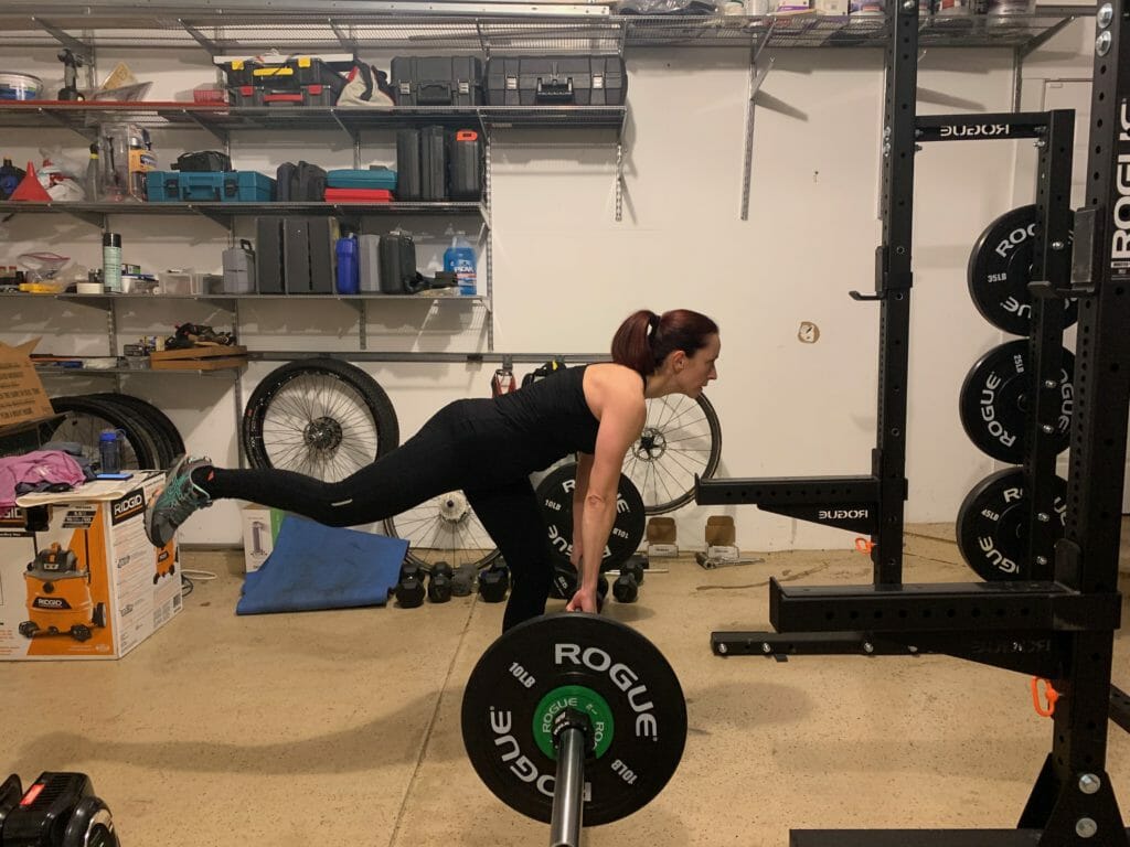 Theia Friestedt doing one-legged RDL with barbell and bumper plates